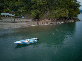 Aerial Drone image of a colorful rowboat just offshore on a Costa Rica Beach