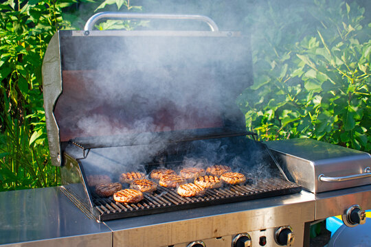 Hamburgers Filling Up The Racks In A Backyard Barbecue On A Beautiful Summer Day -17