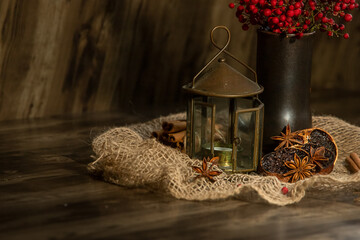 Vintage lantern and dried orange slices with spices on dark wooden background, Christmas meal, New Year dessert