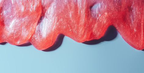 Red liquid slime flowing over blue background