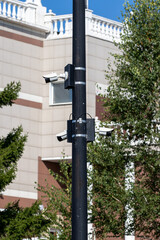 Multidirectional CCTV cameras on a pole in a park area