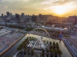 Aerial view of Old Port of Montreal and downtown skyline panorama in summer dusk. Quebec, Canada.