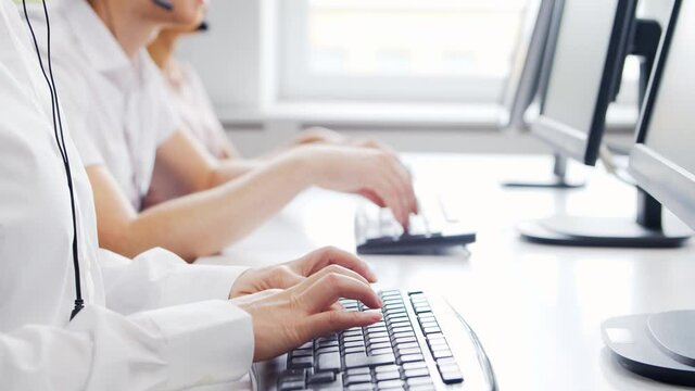 Diverse team of professionals is working in the phone support office. Working day of sales managers in the call center. Concept of business, telephone consulting and problem solving.