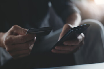 Man using credit card making internet payment for online shopping via mobile banking app on smartphone