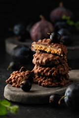 dessert cookies with chocolate, fruits and berries on a dark background