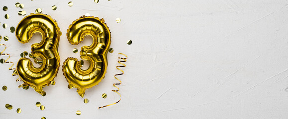 golden foil balloon number thirty three. Birthday or anniversary card with the inscription 33. gray...