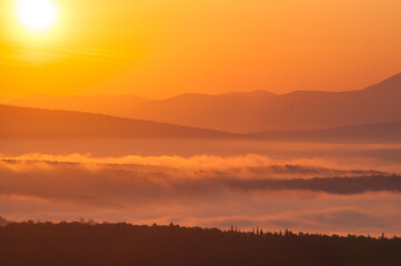 Fototapeta na wymiar sunrise landscape with fog in the mountains