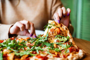 woman eating pizza in the cafe