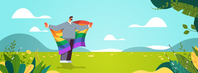 Naklejka na ściany i meble man holding lgbt rainbow flag gay lesbian love parade pride festival transgender love concept