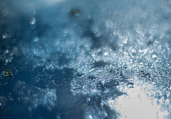 shimmering bright christmas background with defocused bokeh. Winter ice Background with frozen texture.