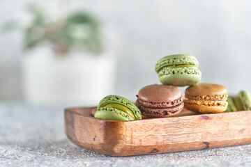 Macarons stacked in a wooden plate