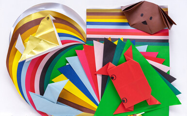 Samples of colored paper and origami style crafts. Children's creativity concept.