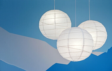 Paper round rice paper lamps on a blue background.