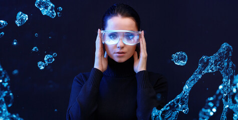 Woman with futuristic tablet in hand. Female using VR glasses. Augmented reality, future technology concept. Blue neon light. Futuristic holographic interface to display data.