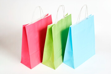 Colorful paper shopping bags on white background