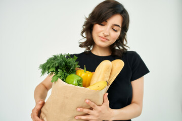 woman in black t-shirt package with groceries healthy food homework