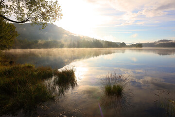 Morning Mist rising on Loch Achray near Aberfoyle, Trossachs National Park, Scotland, UK.