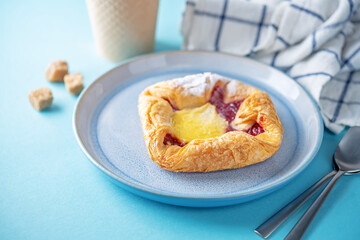 Vanilla cream raspberry jam sweet bun in a plat