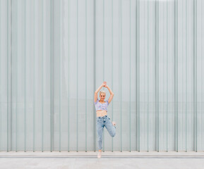 Young caucasian woman outdoor jumping and dancing celebrating success feeling free - advertising copyspace