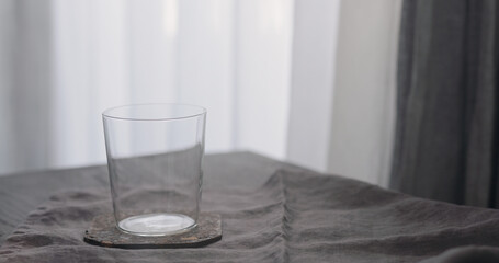 Empty tumbler glass on oak table