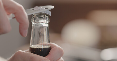 man open glass bottle with fizzy drink