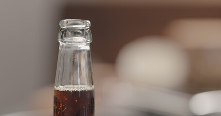 open glass bottle with fizzy drink