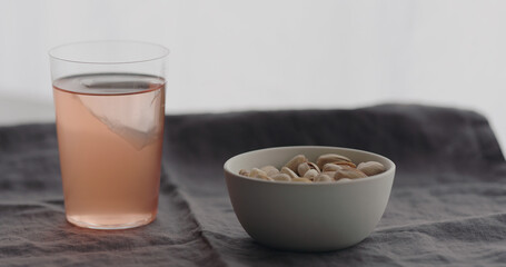 peach lemonade served with salted pistachios