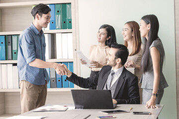 Manager and his team having meeting at meeting room in office.