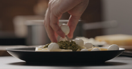 man add mozzarella to penne pesto