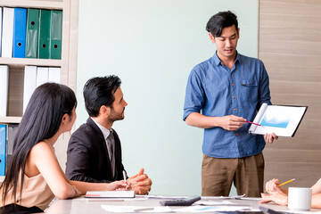 Businessman and team having meeting at meeting room in office.