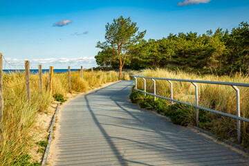 Obraz premium Coastal promenade along beach in Hel town on coast of Baltic Sea, Poland. Hel peninsula is popular place for summer holidays. Hel, Pomerania, Poland