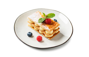 Classic french dessert millefeuille with vanilla cream and fresh berries. isolated on white background	
