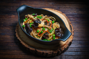 Asian style- restaurant background. Udon noodles with beef Wok