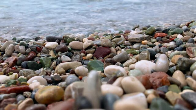 sea waves wash over the pebbles pebble stones on the shore summer vacation concept