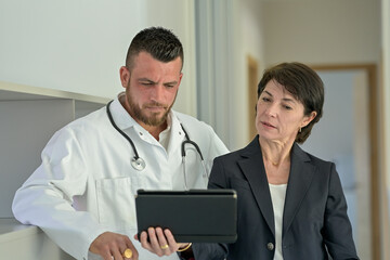 Fototapeta premium Discussion between a doctor and his medical secretary in the office