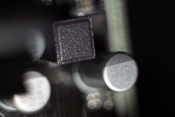 Motherboard with details; bokeh effect lights in the dark background