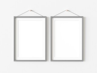 Pair of rectangular picture frames with thin grey border hanging on white wall. Empty template for adding your content. 3D illustration.