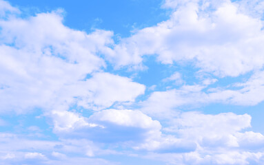 Blue skies with white clouds background. Romantic sky. Abstract nature background of romantic summer blue sky with fluffy clouds. Beautiful puffy clouds in bright blue sky in day sunlight, copy space