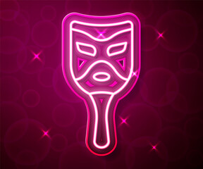 Glowing neon line Carnival mask icon isolated on red background. Masquerade party mask. Vector