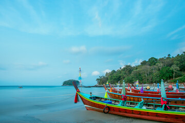 Long-tail boats moored at Kata beach with Koh Pu island in Phuket, Thailand