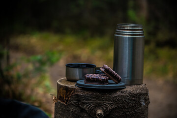 thermos with cookies in the forest