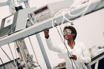 Scientist african american woman working in laboratory with electronic tech single photon detector....
