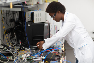 Scientist african american woman working in laboratory with electronic tech. Research and...