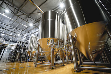 Rows of steel tanks for beer fermentation and maturation in a craft brewery