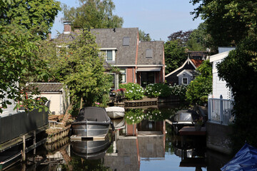 Obraz premium Authentic Dutch architecture. Traditional buildings of the Netherlands. Cute town street view photo. Summer in Europe. 