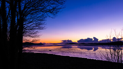 Fototapeta na wymiar A stunning winter sunset reflecting over kirkcudbright Bay, Scotland