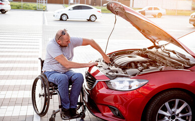 Disabled man in wheelchair check engine his car at parking