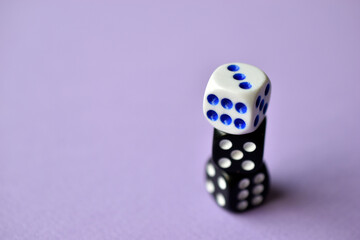 Dice are black and white on a purple background