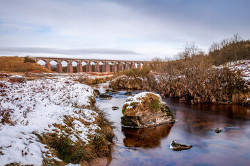Fototapeta na wymiar Long exposure of the Big Water of Fleet and railway viaduct in the winter