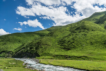 Fototapeta na wymiar Mountains and grasslands along G217 highway in Xinjiang, China in summer